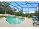 Enjoy this screened-in pool with views of mature trees offering privacy and a relaxing atmosphere for swimming at 6839 Hidden Glade Pl, Sanford, FL 32771