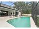 Relaxing screened-in pool area featuring ample seating and a serene backyard view at 6839 Hidden Glade Pl, Sanford, FL 32771