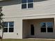 Detailed view of the home's rear facade with a covered patio, emphasizing its architectural details and outdoor living area at 4113 Sagefield Dr, Harmony, FL 34773