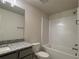Bathroom featuring granite counters, tub with tile backsplash, and a shower at 4113 Sagefield Dr, Harmony, FL 34773