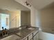 Bathroom featuring double sinks with granite countertops and a large tub, offering a relaxing space at 4113 Sagefield Dr, Harmony, FL 34773