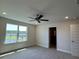 Bedroom with a pond view, enhanced by natural light, and a ceiling fan for added comfort at 4113 Sagefield Dr, Harmony, FL 34773