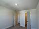 Comfortable bedroom features carpet, neutral walls, and convenient access to closet and ensuite at 4113 Sagefield Dr, Harmony, FL 34773