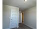 Lightly painted bedroom showcasing paneled doors and neutral carpeting at 4113 Sagefield Dr, Harmony, FL 34773