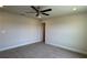 A spacious carpeted bedroom featuring a ceiling fan and neutral wall paint, creating a serene retreat at 4113 Sagefield Dr, Harmony, FL 34773