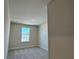 Neutral bedroom with a window providing natural light and carpeted floors at 4113 Sagefield Dr, Harmony, FL 34773
