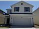 Attractive two-story home featuring a large garage and neutral color palette at 4113 Sagefield Dr, Harmony, FL 34773