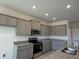 Modern kitchen featuring gray cabinets, stainless steel appliances, and granite countertops at 4113 Sagefield Dr, Harmony, FL 34773