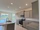 Modern kitchen features stainless steel appliances, granite countertops, and ample cabinet space at 4113 Sagefield Dr, Harmony, FL 34773