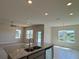 Spacious kitchen with granite countertops, stainless steel appliances, and a view of the backyard pond at 4113 Sagefield Dr, Harmony, FL 34773