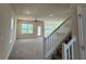 Spacious living room showcasing stairs with carpet, neutral walls, and natural light at 4113 Sagefield Dr, Harmony, FL 34773