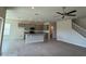 Open floor plan with kitchen island, gray cabinets, and a carpeted living area with large windows at 4113 Sagefield Dr, Harmony, FL 34773