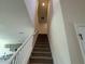 Carpeted staircase leading to the upper level with white banister and neutral walls at 4113 Sagefield Dr, Harmony, FL 34773