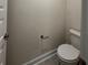 Close-up view of a toilet in a simple, neutral-toned bathroom, showcasing essential fixtures at 4113 Sagefield Dr, Harmony, FL 34773