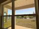 Beautiful view of a pond from a large picture window, offering serene landscape scenery from indoors at 4113 Sagefield Dr, Harmony, FL 34773