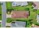 Aerial view of a house with a tile roof, lush lawn, and a paved driveway at 4738 St Andrews Arc, Leesburg, FL 34748