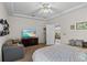 Bright main bedroom boasts a ceiling fan, ensuite bathroom, and views to the living areas and beyond at 4738 St Andrews Arc, Leesburg, FL 34748