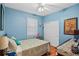 Bedroom featuring blue walls, hardwood floors, window and closet space at 4738 St Andrews Arc, Leesburg, FL 34748