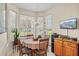 Cozy breakfast nook with natural light, a charming chandelier, and a scenic view at 4738 St Andrews Arc, Leesburg, FL 34748