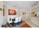 Elegant dining room featuring a stylish chandelier, modern decor, and hardwood flooring at 4738 St Andrews Arc, Leesburg, FL 34748