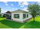 Home exterior showing a screened-in lanai, well-maintained lawn, and tasteful landscaping at 4738 St Andrews Arc, Leesburg, FL 34748