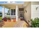Welcoming front porch with decorative walkway, potted plants, and charming screened entrance at 4738 St Andrews Arc, Leesburg, FL 34748