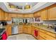 Bright kitchen with granite countertops, stainless steel appliances, and ample cabinet space at 4738 St Andrews Arc, Leesburg, FL 34748