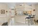 Open kitchen with granite countertops and bar seating flows seamlessly into the dining and living areas at 4738 St Andrews Arc, Leesburg, FL 34748