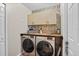 Laundry room with washer, dryer and storage cabinets at 4738 St Andrews Arc, Leesburg, FL 34748