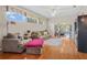 Comfortable living room with hardwood floors, large windows, and an open layout to the backyard at 4738 St Andrews Arc, Leesburg, FL 34748