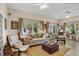 Inviting living room boasts large windows, a ceiling fan, and comfortable seating for relaxing at 4738 St Andrews Arc, Leesburg, FL 34748