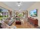 Bright living room with tiled floors, large windows, and backyard views, perfect for entertaining at 4738 St Andrews Arc, Leesburg, FL 34748