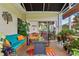 Enclosed patio with comfortable seating, plants, and view of the backyard at 4738 St Andrews Arc, Leesburg, FL 34748