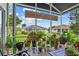 Enclosed patio featuring greenery, seating, and a view of the landscape at 4738 St Andrews Arc, Leesburg, FL 34748