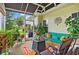 Enclosed patio with comfortable seating, plants and view of backyard at 4738 St Andrews Arc, Leesburg, FL 34748