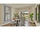 Stylish dining room with round table, modern chairs, large window, and sophisticated decor for elegant dining at 5650 Paddock Fence Ln, Apopka, FL 32712