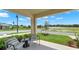 Inviting front porch with seating area overlooking the lush, green landscaping and beautiful views at 5650 Paddock Fence Ln, Apopka, FL 32712