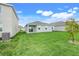 Spacious backyard with a lush lawn and sliding glass doors leading to covered patio at 5724 Camilla St, St Cloud, FL 34771