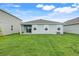 Wide backyard featuring a well-manicured lawn, patio area, and light-blue exterior at 5724 Camilla St, St Cloud, FL 34771