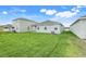 Manicured backyard with lush green grass and view of the home's exterior at 5724 Camilla St, St Cloud, FL 34771