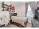 Bright bedroom with neutral tones, a full size bed, and open shelving for decor at 5724 Camilla St, St Cloud, FL 34771