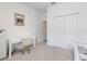 Bedroom featuring a white desk, chair, and closet with double doors, creating a clean and organized space at 5724 Camilla St, St Cloud, FL 34771