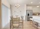 Dining area features modern chandelier, bright windows, and adjoins stainless steel kitchen at 5724 Camilla St, St Cloud, FL 34771