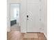 Bright entryway with wood-look floors, leading to a view of a bedroom at 5724 Camilla St, St Cloud, FL 34771