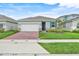 Charming single-story home featuring a brick driveway, well-kept lawn, and inviting curb appeal at 5724 Camilla St, St Cloud, FL 34771