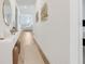 Bright hallway with wood-look floors, console table, and elegant decor leading to living areas at 5724 Camilla St, St Cloud, FL 34771