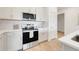 Modern kitchen featuring stainless steel appliances, marble backsplash, and white cabinets at 5724 Camilla St, St Cloud, FL 34771