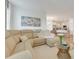 Bright and open living area flowing into a modern kitchen with a breakfast bar and stainless steel appliances at 5724 Camilla St, St Cloud, FL 34771