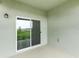 Neutral patio features sliding glass doors offering views of the lush green landscape at 5724 Camilla St, St Cloud, FL 34771