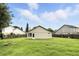 The back of the house has a door to the yard which is surrounded by a wood fence at 7810 Wortham Ct, Orlando, FL 32825